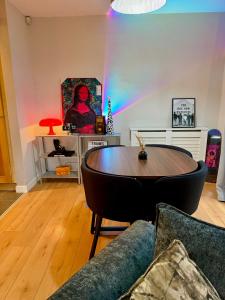 a living room with a table and a rainbow at Ebrington apartment central in Clooney Park