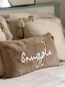 a pillow with the word sympathy written on it on a bed at Ebrington apartment central in Clooney Park