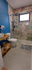 a bathroom with a toilet and a glass shower at Terras do Salvado Agroturismo in Fundão +52 photos