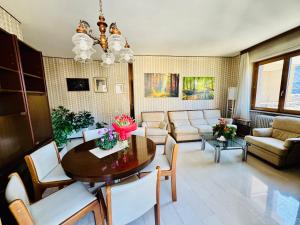 a living room with a table and a couch at Nido tra monti in Sondrio