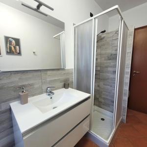 a bathroom with a sink and a shower at Villa Glory Mountain Lake Iseo Hospitality in Bossico +35 photos