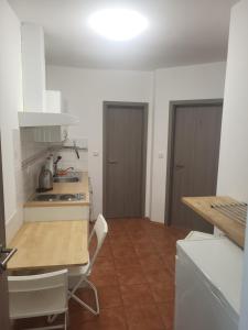 a kitchen with a table and a stove top oven at Komárov Apartment 2 in Komárov