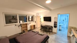 a living room with a bed and a table and a television at Apart Schwalbennest in Imst +102 photos