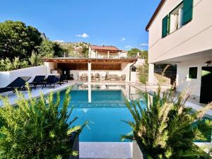 a swimming pool in the backyard of a house at Mare`s Private House 1st floor with Pool in Karlobag