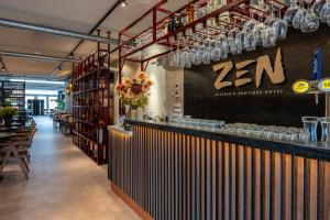 a bar in a restaurant with glasses on the wall at Zen Kitchen & Boutique Hotel in Brouwershaven +37 photos