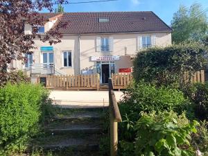 a white house with a wooden fence in front of it at auberge de louroux in Louroux-de-Bouble