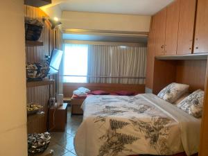 a bedroom with a large bed and a window at Monalisa sweet house - Appartamento Marilleva 1400 in Marilleva