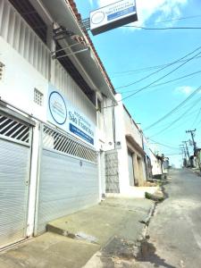 a building with two garage doors on the side of it at Hospedagem São Francisco in São Luís