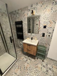 a bathroom with a sink and a shower and a mirror at Apartmány Malý Princ in Horní Blatná +35 photos