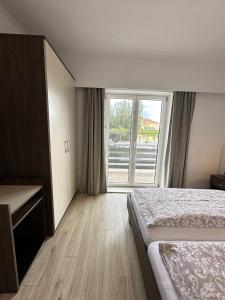 a bedroom with a bed and a large window at Apartments Božena in Vodice +94 photos