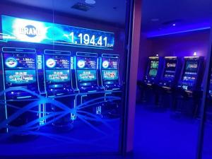 a row of slot machines in a room with blue lights at Old house by the stream in Donja Stubica