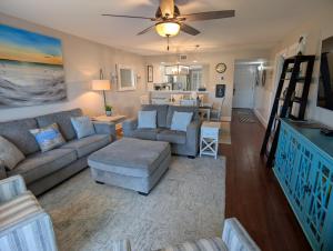 a living room with a couch and a table at Gulf Balcony - Boutique Comforts & 2 King Suites in Fort Walton Beach +42 photos