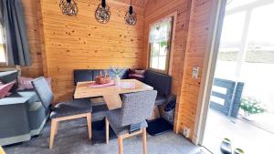 a wooden room with a wooden table and chairs at Haeuslein-Waldesruh in Muldenberg