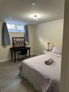 a bedroom with a bed and a desk and a window at New and Stylish 3BR Private Basement Apartment with 3 Baths & Parking in Richmond Hill