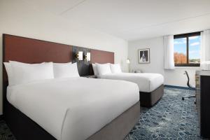 a hotel room with two beds and a window at Doubletree By Hilton Concord Downtown in Concord +15 photos