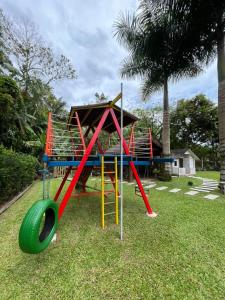 a playground with a slide and a swing at Familien Haus Pousada in Pomerode +53 photos