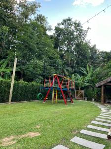 a park with a playground in the grass at Familien Haus Pousada in Pomerode
