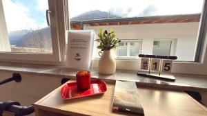 a counter with a window with a book and a candle at Apart Schwalbennest in Imst
