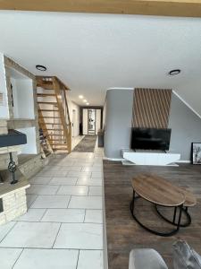 a living room with a table and a couch at Sky Loft Schwarzach in Schwarzenbruck