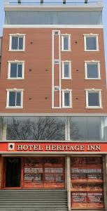 a building with a hotel heritage inn sign in front of it at Hotel Heritage Inn in Samastīpur