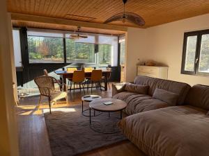 a living room with a couch and a table at Chalet dans la nature in Palisse