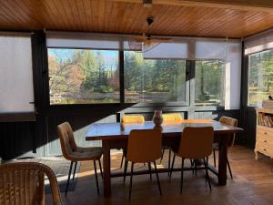 a dining room with a wooden table and chairs at Chalet dans la nature in Palisse +23 photos