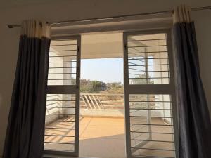 a sliding glass door with a view of a balcony at Harmony Palace Guest House in Nashik