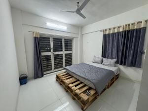 a bedroom with a bed and a window at Harmony Palace Guest House in Nashik +15 photos