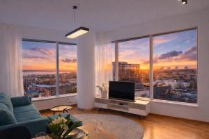 a living room with a view of a city at Panoramic Sea View - 12th floor in Tallinn