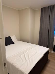 a white bed in a room with a window at Gardermoen Airport, 5Min in Sand