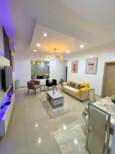 a living room with a couch and a table at Modern 3BR in Lekki Phase 1 in Lekki