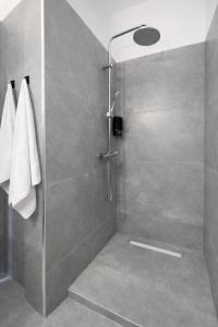 a shower with a glass door in a bathroom at Ameli Studio ,Balcony with Mountain View, Kitchenette, 1km to Beach by likeyourhome in Corfu +17 photos