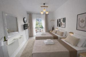 a living room with two beds and a couch at Ameli Studio ,Balcony with Mountain View, Kitchenette, 1km to Beach by likeyourhome in Corfu