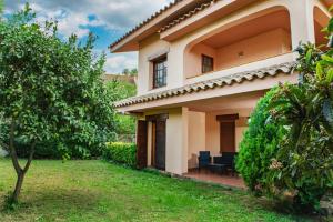 a villa with a garden and a house at Villa Ficus in Lloret de Mar +32 photos
