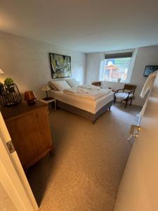 a bedroom with a bed and a table and a chair at Winding B&B Silkeborg in Silkeborg +46 photos