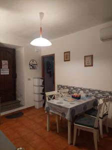 a dining room with a table and chairs and a light at L'Antica Corte in Mongardino