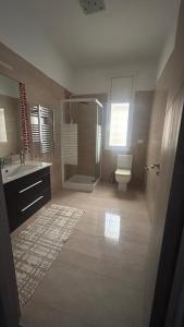 a bathroom with a shower and a toilet and a sink at Da Dora in Dar el Haj Ahmed Souid +11 photos