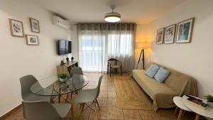 a living room with a couch and a table at Rhys Houses in Altea