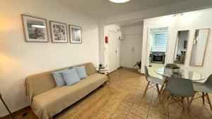 a living room with a couch and a glass table at Rhys Houses in Altea