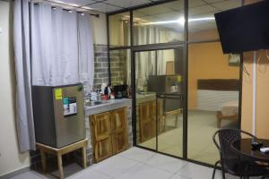 a kitchen with a refrigerator and a sink in a room at Hospedaje Ofe,S #3 in Santiago