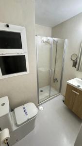 a bathroom with a shower and a toilet and a sink at Rhys Houses in Altea +17 photos