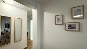 a hallway with three framed pictures on the wall at Rhys Houses in Altea