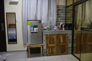 a kitchen with a refrigerator and a sink at Hospedaje Ofe,S #3 in Santiago