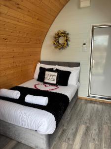 a bedroom with a bed with a happy thanksgiving pillow at The Midi Pod in Aberystwyth