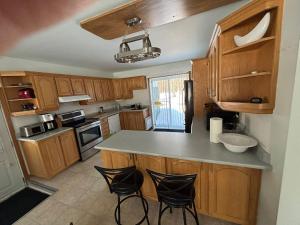 a kitchen with wooden cabinets and a counter top at Finca Saddiki in Namur