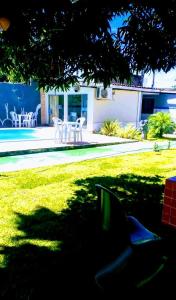 a shadow of a tree in a yard with a table and chairs at Bio natura in Marechal Deodoro