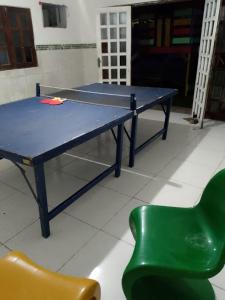 a ping pong table and a green chair at Bio natura in Marechal Deodoro