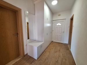an empty room with white walls and a white door at Apartman TB in Trebinje