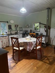 a kitchen with a table and chairs in a room at Casa Krampus Hospedaje y Cervecería in Valdivia