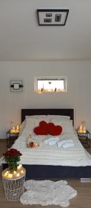 a bedroom with a bed with red pillows on it at Agroturystyka W kurniku z jacuzzy in Lubań +42 photos